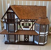 Tutor style doll house with cedar shake roof.