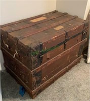 Antique flat top steamer trunk with plenty of