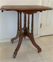 Victorian table on caster wheels - four leg base.