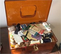 Vintage sewing box filled with supplies,