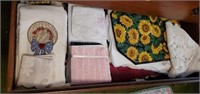 Tablemats, dishtowels and contents of drawer