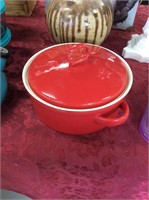 Large covered red casserole dish