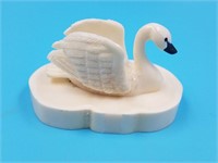 Small ivory carving of a swan by Fred Mayac on an
