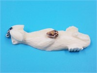 Small ivory pendant of an otter with small sea she