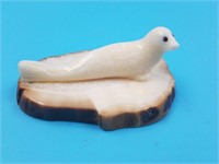 Small ivory carving of a seal with baleen inset ey