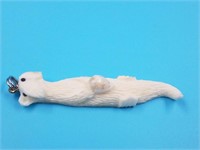 Ivory pendant of an otter by Utuqsiq with small se