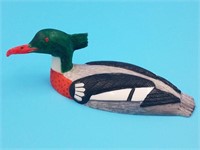 Colored scrimshawed ivory carving of a red breaste