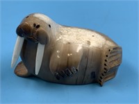 Fossilized ivory carving of a walrus with white iv