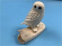 Old ivory carving of an owl, with fossilized ivory