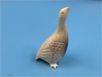 Old fossilized ivory carving of a bird, missing ba
