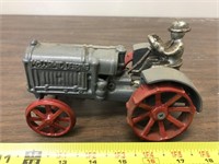 Cast iron McCormick Deering tractor with guy