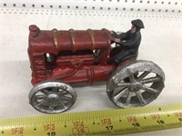 Vintage cast iron tractor with guy