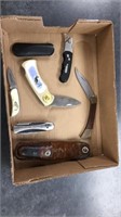 5 pocket knives and two holders