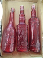 3 red glass bottles with corks- 1 cork missing