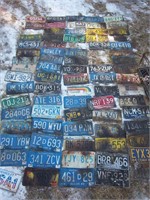 variety of license plates, some damaged