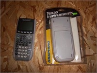 two Texas Instruments silver edition calculators