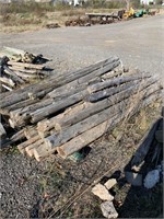 SKID OF WOODEN CEDAR POSTS MOST ARE 8FT LONG