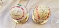 2 signed baseballs in displays and 1 unsigned