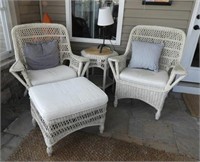 Pair of wicker patio lounge chairs and white