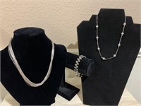 Two sterling necklaces and one sterling bracelet,