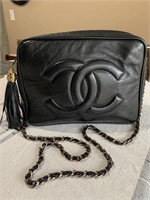 Chanel quilted black double zipper camera bag.