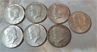 Seven 1964 Kennedy half dollars