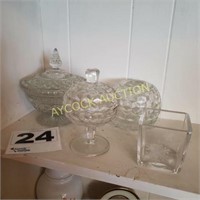 Shelf full of glass ware (candy dishes)