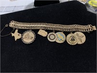 12 karat GF charm bracelet with seven charms.