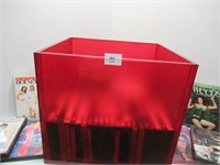 Red Plastic Storage Bin with Assorted DVDs