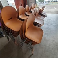 Lot of orange stackable chairs x75