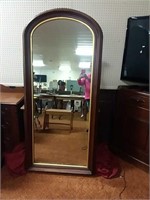 Tall wood-framed wall mirror