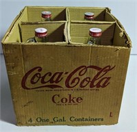 (4) One Gal. Glass Coca-Cola Jugs with lids in
