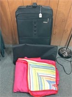 black luggage & blanket