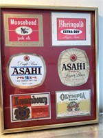 Framed collection of beer labels barware