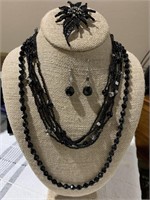 Selection of black vintage jewelry includes a