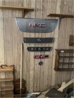 Collection of car grills and emblems on wall