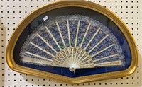 Fan shaped framed shadowbox with a lace and