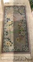 Small area carpet with a floral design and full
