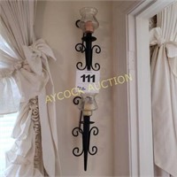 2 black sconces with candles