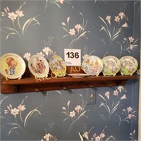 Shelf with AVON collectibles small plates (7)