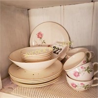 Shelf of antique dishes with pink roses