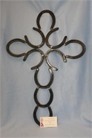 Cross made entirely from horse shoes.