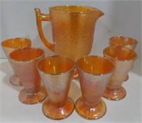 Pitcher with six pedestal cups. Iridescent orange