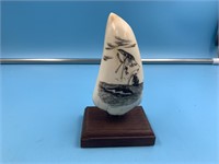 Scrimshawed whales tooth depicting an unfortunate