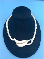 Ivory beaded necklace, center piece has gold inlay