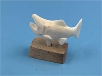 Ivory carving of a salmon by Leonard Savage on a w