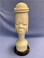 Enormous ivory carving of a woman's head on a wood