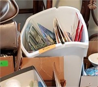 Trash can full of gift bags, picture frames,