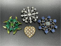 Four jeweled brooches