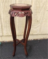 Nice wooden carved plant stand. Marble style top